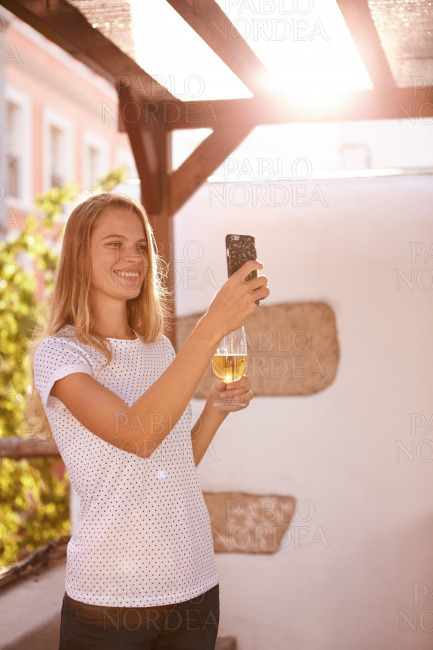 Lovely smiling blond girl taking a selfie