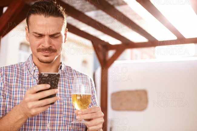 Man with a beer and cellphone