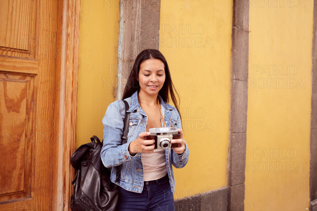 Pretty young girl looking at her camera smiling