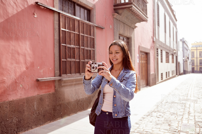 Pretty young girl taking a picture with her camera stock photo