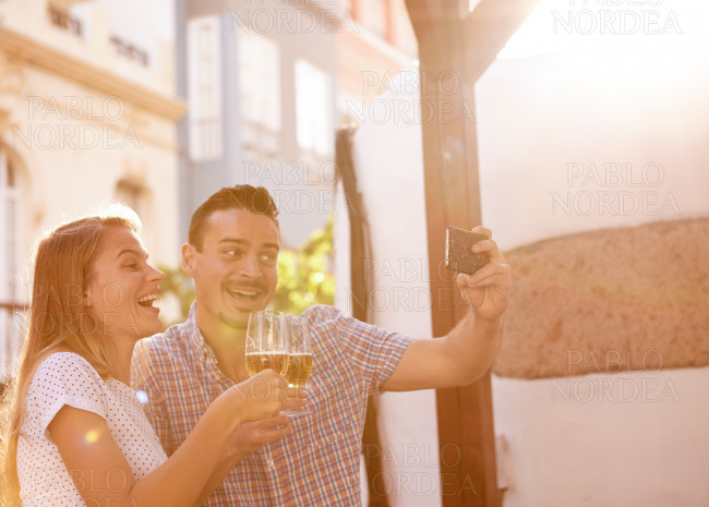 Selfie taking couple with some beer