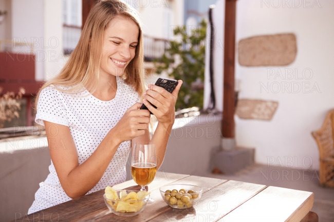 Smiling blond girl reading a message