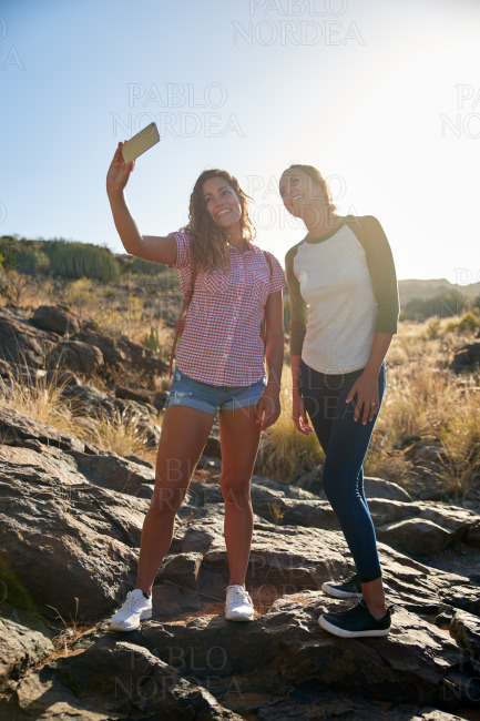 Two girls on a rock posing