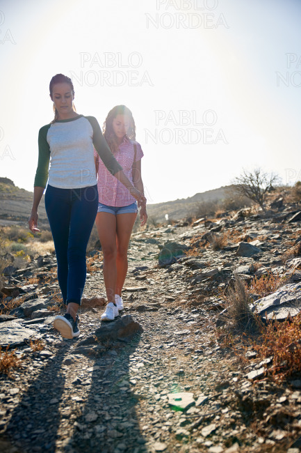 Two pretty girls walking down hill