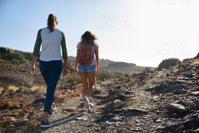 Two young ladies strolling up hill