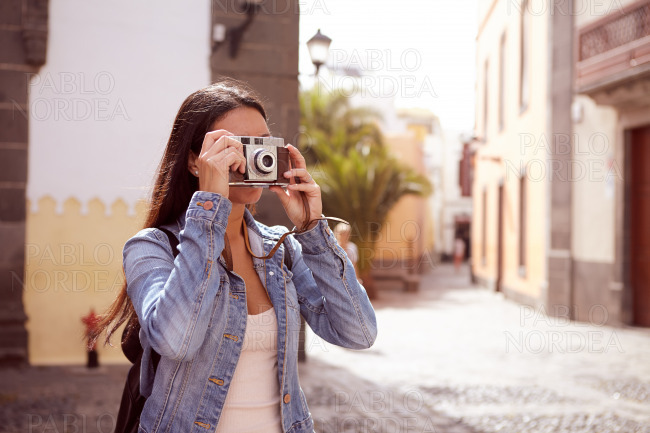 Young girl focusing her old camera