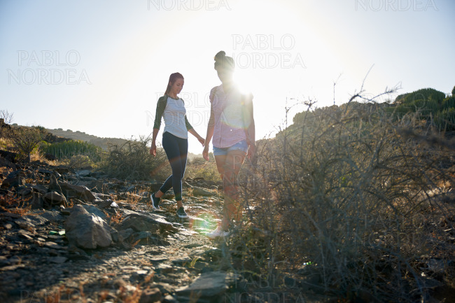 Young girls walking down rocky path